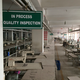 A sign is seen as a building safety assessment is being conducted at an Adorn Knitwear garments factory in Dhaka, December 9, 2014. Adorn is a small business not far from the rubble of Rana Plaza, a Dhaka suburb building that collapsed in April 2013 killing more than 1,100 people, most low-paid seamstresses, and prompting a costly safety overhaul at plants large and small. Last month, Adorn's production lines were silent and its sewing machines gathering dust as the lengthy process of checking the building for structural weakness was underway. Picture taken December 9, 2014. To Match Insight BANGLADESH-GARMENTS/ REUTERS/Krista Mahr (BANGLADESH - Tags: BUSINESS) - GM1EB150U3Y01